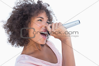 Attractive woman singing in microphone