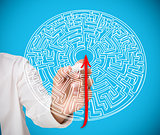 Businessman drawing red line to centre of maze