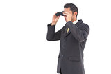 Businessman looking with binoculars