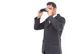 Handsome businessman with binoculars