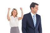Businesswoman with raised arms and her coworker