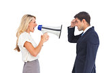 Businesswoman shouting at a businessman with megaphone
