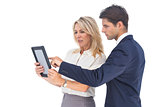 Businessman and woman pointing something on digital tablet