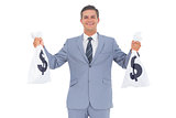 Businessman with cash bag in each hands