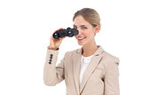 Businesswoman smiling at the camera with binoculars