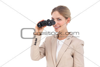 Businesswoman smiling at the camera with binoculars