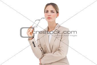 Serious businesswoman holding glasses