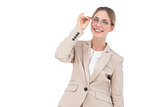 Smiling businesswoman holding her glasses