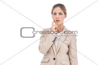 Thinking businesswoman looking at the camera