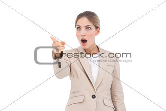 Astonished businesswoman pointing something