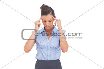 Businesswoman thinking with fingers on her temples
