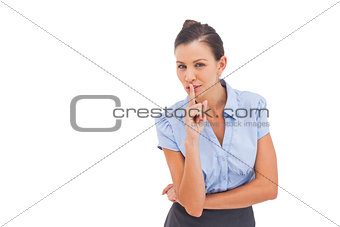 Businesswoman with finger on lips