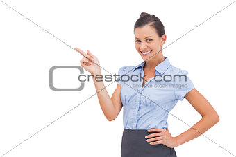 Cheerful businesswoman indicating something