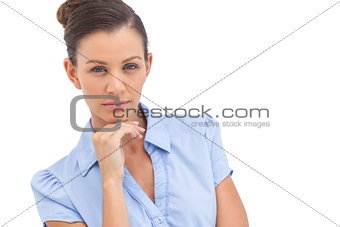 Serious businesswoman with hand on chin