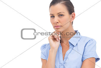 Stern businesswoman with hand on chin