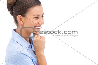 Laughing businesswoman with hand on chin