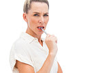 Concentrated businesswoman with pen on mouth