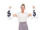 Smiling businesswoman holding money bags