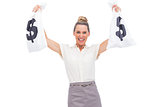 Smiling businesswoman showing money bags