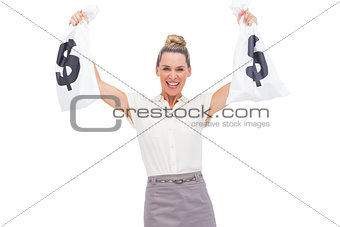 Smiling businesswoman showing money bags