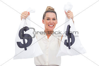 Smiling businesswoman carrying cash bags