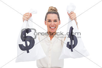 Cheerful businesswoman carrying cash bags