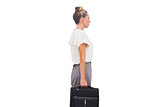 Side view of businesswoman standing with briefcase