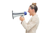 Side view of a blonde businesswoman using megaphone