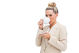Smiling businesswoman drinking a cup