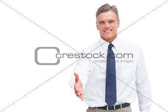 Smiling mature businessman ready to shake hand