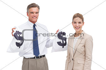 Smiling mature businessman and coworker showing money bags