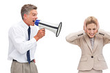 Mature businessman shouting at his coworker with megaphone