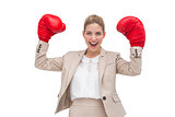 Cheering businesswoman with boxing gloves