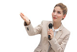 Businesswoman with microphone pointing at something