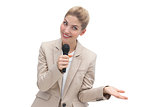 Amazed businesswoman speaking on microphone