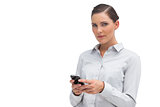 Unsmiling businesswoman holding cellphone