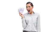 Cheerful businesswoman showing lot of money