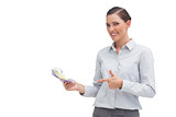 Happy businesswoman pointing to money in her hand