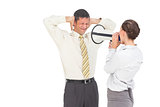 Businesswoman yelling at businessman with megaphone