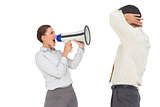 Businesswoman shouting at businessman with megaphone