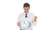 Excited businessman holding a clock