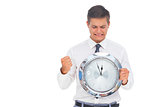 Anxious businessman holding and looking at clock