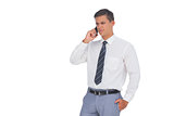 Unsmiling businessman on the phone