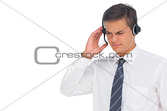 Call centre agent using headset and touching it
