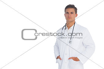Doctor frowning with hands in pockets