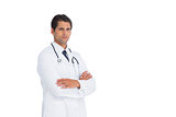 Handsome doctor standing with arms crossed