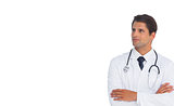 Confident doctor with arms crossed looking up