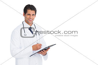 Handsome doctor holding a clipboard and pen