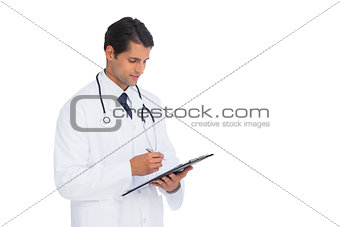 Smiling doctor holding pen and clipboard