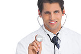 Doctor smiling and holding up stethoscope